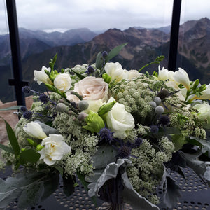 gorgeous wedding floral arrangement with rocky mountains in background